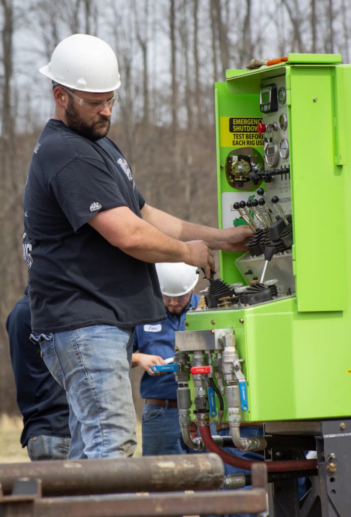Master Sonic Driller at controls of Sonic Drill Rig