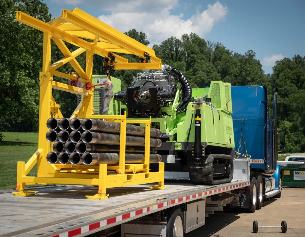 TUG pipe handling for sonic drill rig for transport